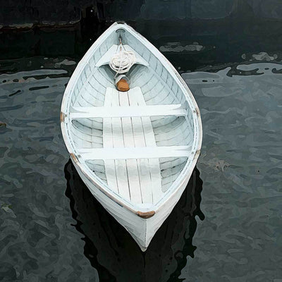 The White peapod boat vertically centered in the frame as graphic element against dark water.A traditional New England style boat resembling  a  canoe with double pointed ends like  the peapod vegetable .